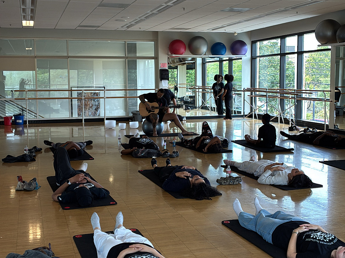 Students lying down on yoga mats.