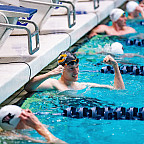 Ezra celebrating in the pool after a win.