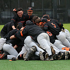 Baseball team players celebrating by jumping together in giant dog pile.