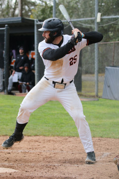 Action shot of Jack swinging a bat
