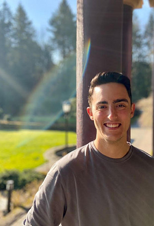 Jordan smiling outside on the L&C campus.