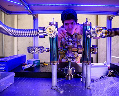 A professor working on a large metal instrument.