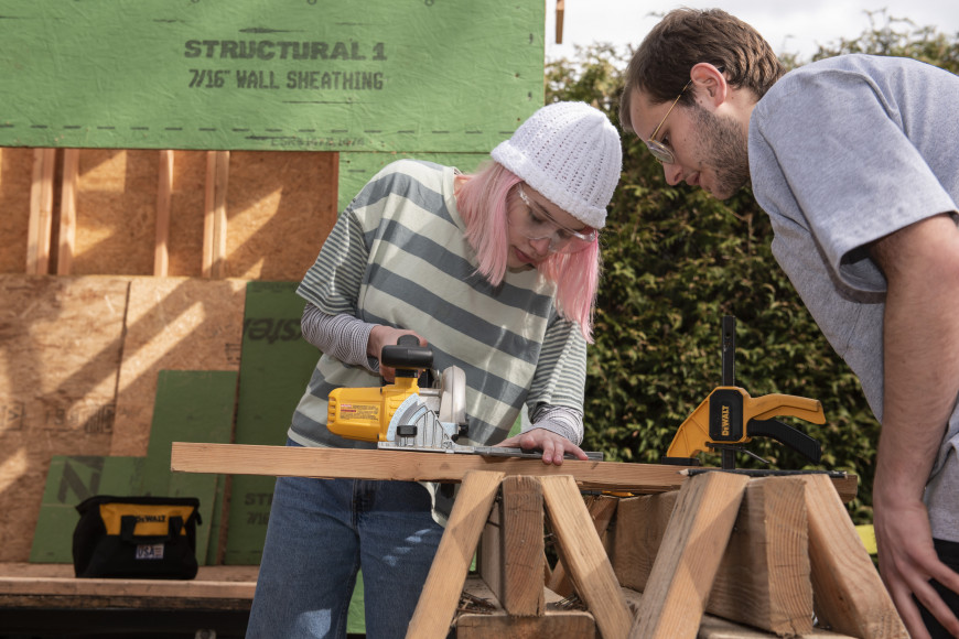 Cofounder Elijah Black BA '23 assists a student with power tools.