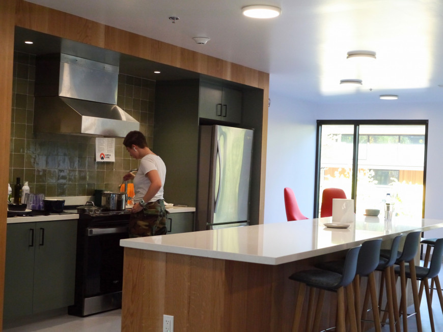 A student cooks in the Odell Hall kitchen, which is adjacent to the lounge area.Credit: Tara Elsa BA '26