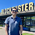 Person in front of a blockbuster sign