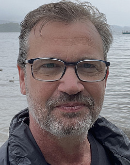 Brad Wilkin on a beach